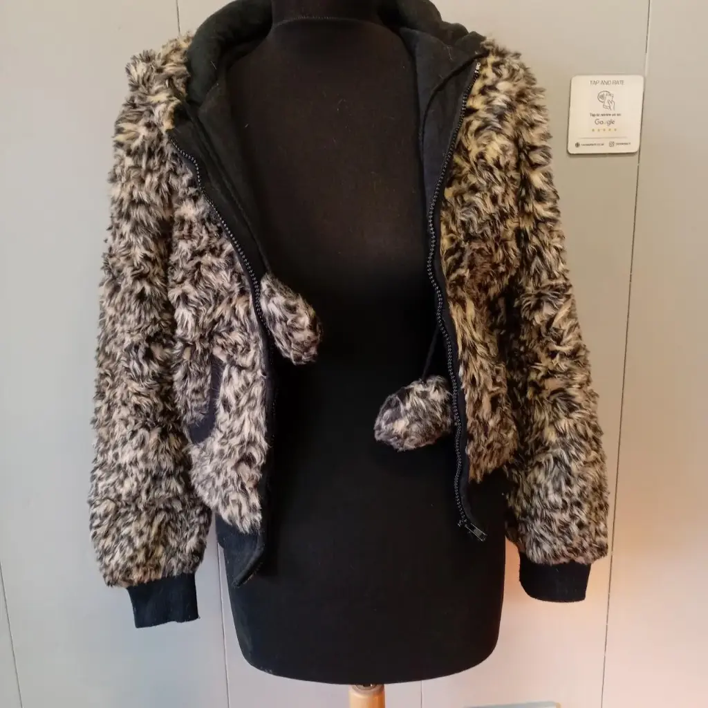 Black and tan faux fur zip-up jacket with hood pockets pom-poms Size 10
